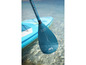 Een Aqua Marina paddleboard met peddel in het water.