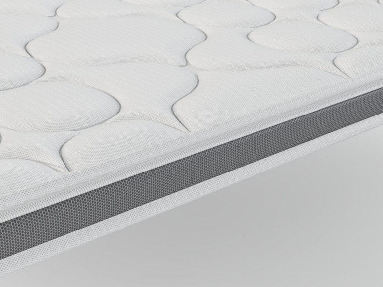 Un matelas blanc avec une bordure grise.