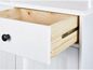Witte kast met open lade, zichtbaar houten interieur en zwarte knop.