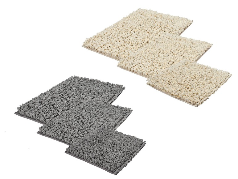 Drie badmatten in verschillende maten, beige en grijs.