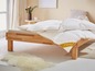 Een wit dekbed van Palette op een houten bedframe.