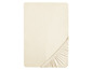 Een beige hoeslaken met elastiek.