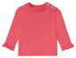 Un t-shirt rose à manches longues avec des volants pour bébés.