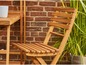 Een houten tuinstoel en -tafel