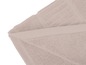 Tapis de bain beige à texture douce.