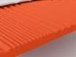 Un matelas en mousse orange avec une surface cannelée.