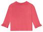 T-shirt rose à manches longues avec des volants pour bébés.