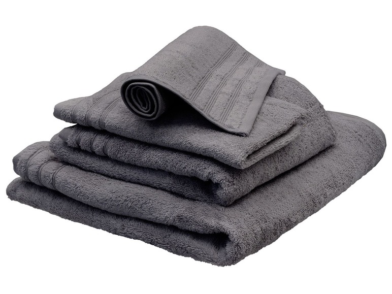 Une pile de serviettes de bain gris foncé.
