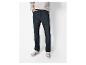 Une personne portant un sweat-shirt clair, un jean bleu foncé et des baskets.