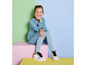 Een meisje in een blauwe jurk en witte sneakers.
