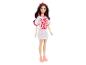 Barbie pop met een witte jurk met gekleurde stippen en de tekst 'Twist & Turn. Up the volume.'