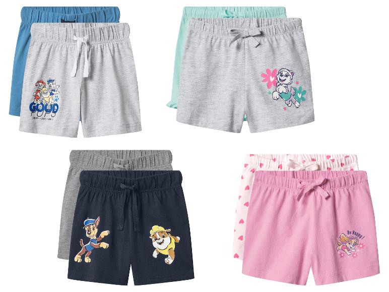 Vier sets kinderbroekjes in diverse kleuren met cartoonhondenprints.
