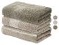 Pile de serviettes en coton beige et vert olive avec motif de feuilles, avec échantillons de couleurs.