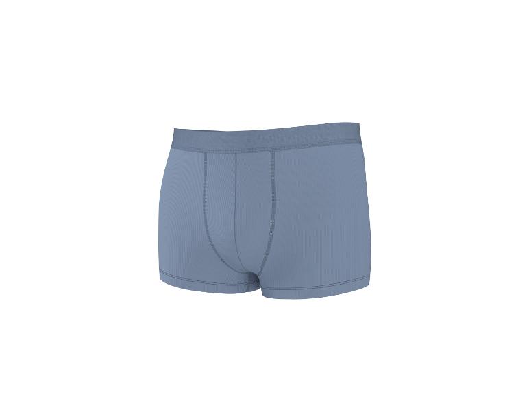 Caleçon boxeur homme bleu clair avec texture côtelée et coutures visibles.