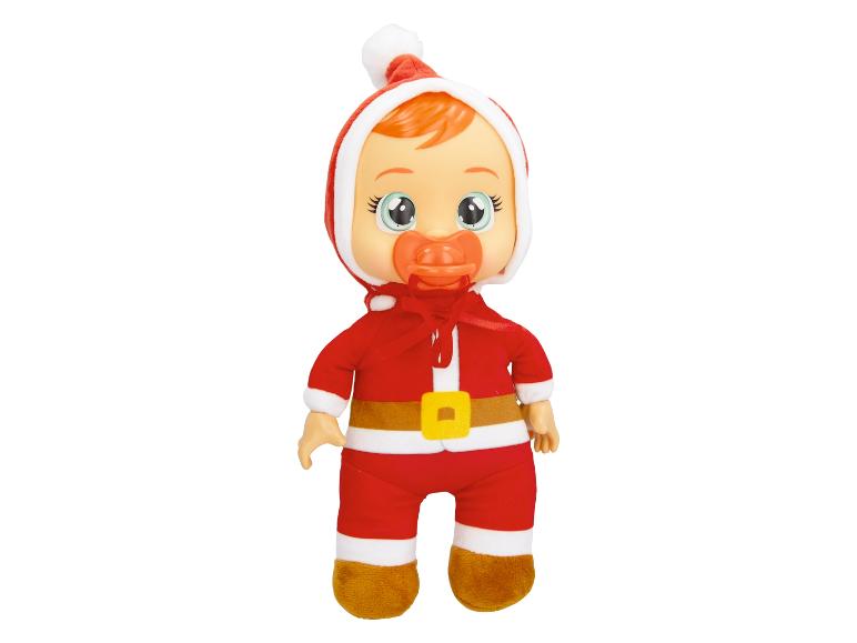 Une poupée de bébé en costume de Père Noël rouge avec une sucette.