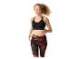 Vrouw rent in zwarte sportbeha en legging met rood-groen patroon