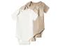 Trois bodys de bébé à manches courtes en blanc et deux nuances de beige.
