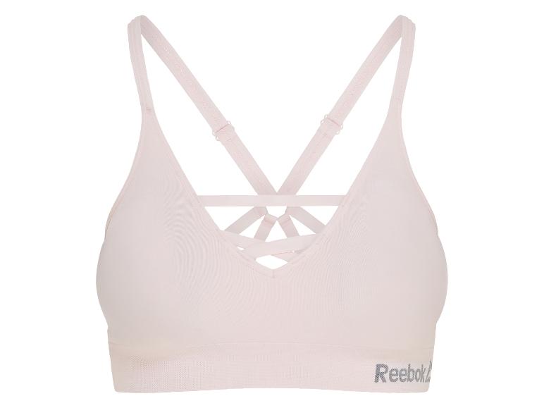 Soutien-gorge de sport rose clair avec bretelles croisées et logo texte.