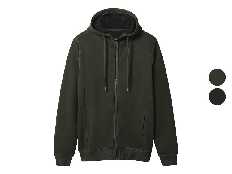 Donkergroene hoodie met rits en twee kleurstaaltjes.