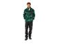 Un homme en veste polaire verte et noire avec le texte 'PARKSIDE' et un pantalon de travail noir.