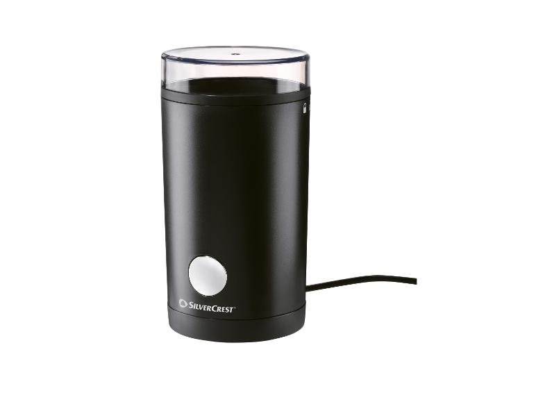 Moulin à café électrique noir SilverCrest avec couvercle transparent et cordon d'alimentation.