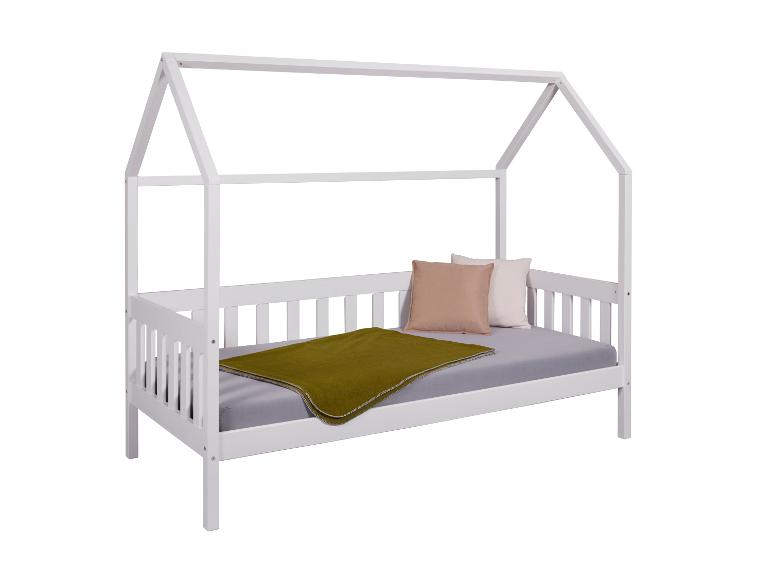 Lit d'enfant blanc en bois avec un auvent.