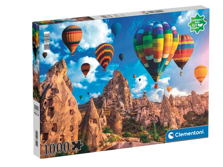 Puzzel van 1000 stukjes met heteluchtballonnen boven rotsformaties, met de tekst 'compact box Eco Friendly'.
