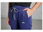 Donkerblauwe joggingbroek met een groen logo.