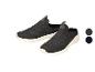 Grijze mesh sportschoenen met witte zool en groene details.