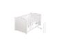 Lit bébé blanc avec barreaux amovibles et matelas.