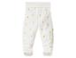 Pantalon de bébé blanc avec pieds et imprimé canardons jaunes