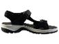 Sandale de sport noire avec semelle blanche et détails ajustables.