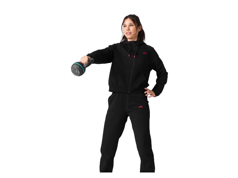 Vrouw in een zwart trainingspak met kettlebell.