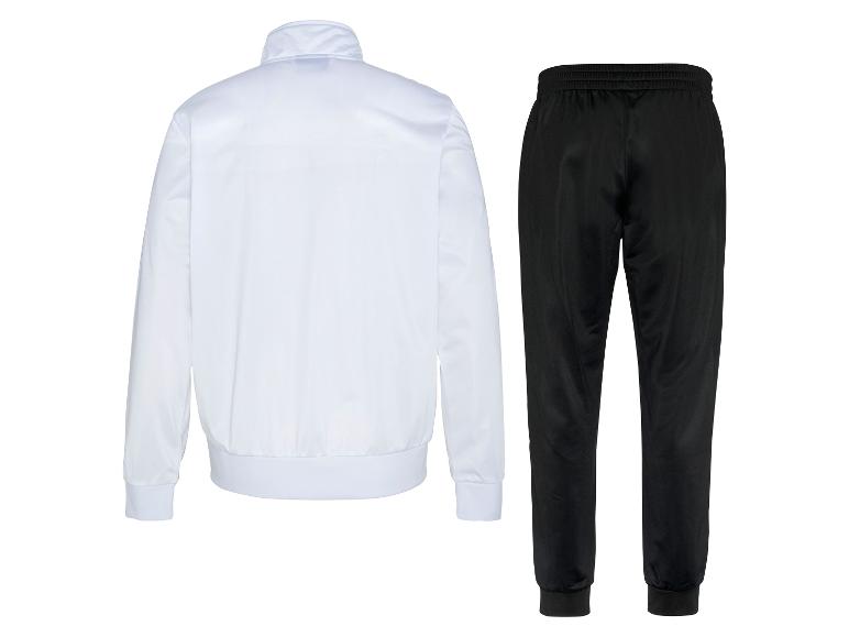 Ensemble de survêtement blanc et noir, avec veste blanche et pantalon noir.