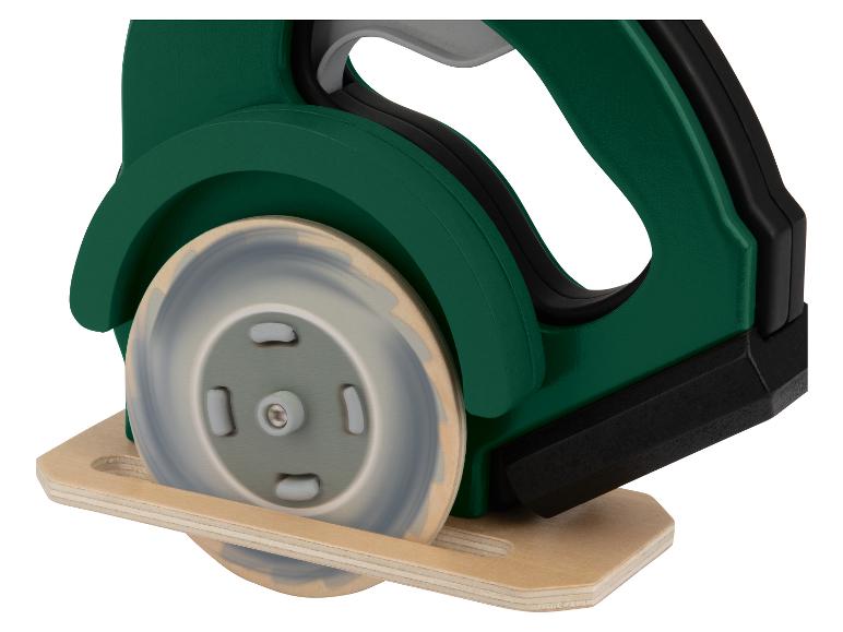 Groen plastic speelgoed in de vorm van een cirkelzaag