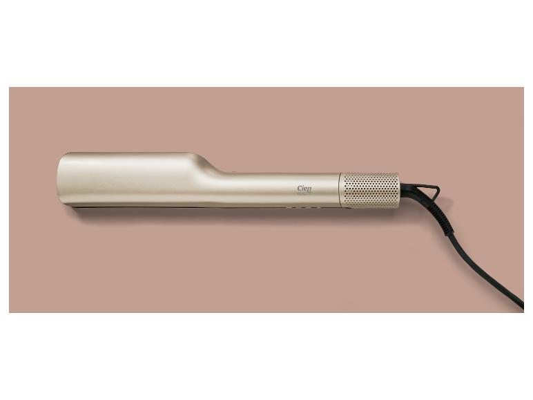 Gouden Cien Beauty stijltang met zwart snoer op een roze achtergrond
