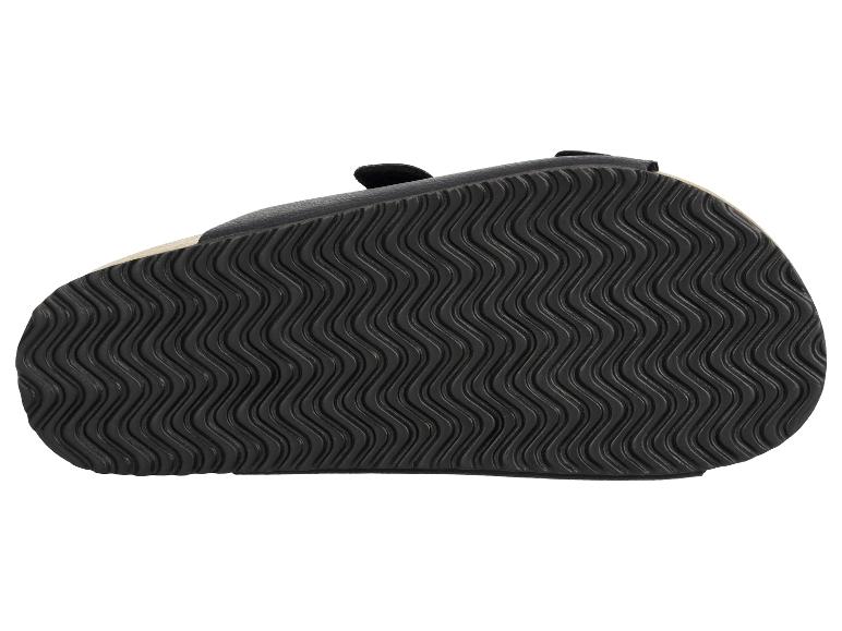 Semelle noire de sandale avec motif ondulé.