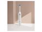Brosse à dents électrique blanche Cien Beauty avec tête verte et bleue sur fond beige