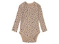 Un body bébé beige à pois bleus.