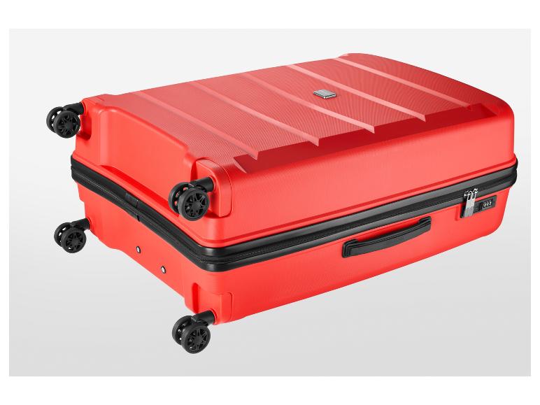 Valise rouge à quatre roues, fermeture éclair et serrure à combinaison.