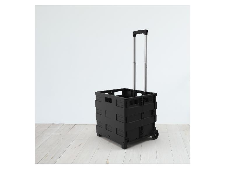 Un chariot de courses pliable noir avec des roues.