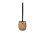 Brosse de toilette dorée avec manche noir.