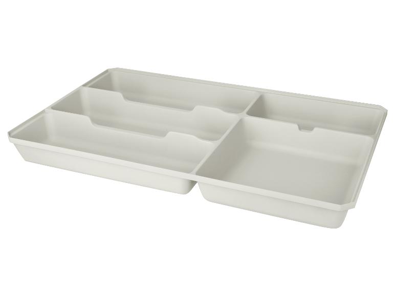 Witte lade-organizer met meerdere vakken voor keukengerei.