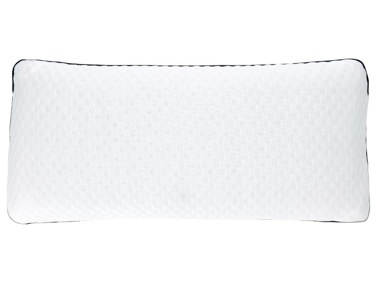 Oreiller rectangulaire blanc avec un motif texturé.