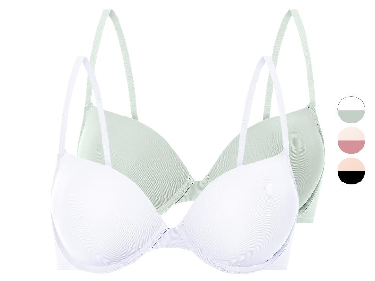 Twee witte en groene bh's.