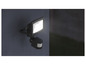 Un lampadaire extérieur noir avec capteur, fixé à un mur.