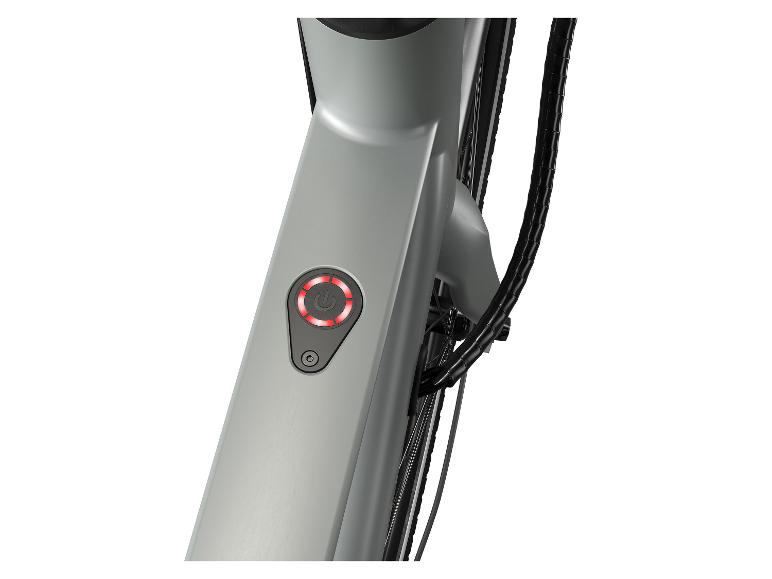 Een close-up van een grijze e-bike met rode LED-verlichting op de aan/uit-knop.