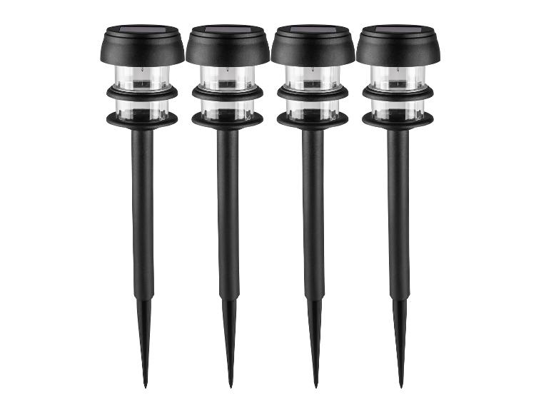 Quatre lampes de jardin solaires noires avec couvercles en plastique transparent