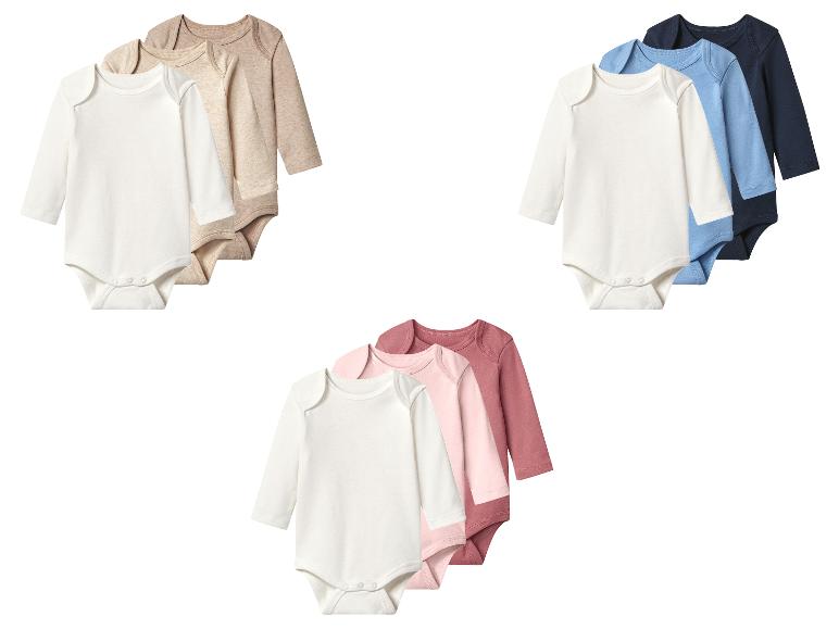 Set van drie babyrompertjes met lange mouwen in wit, beige en lichtbruin.