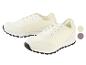 Twee paar witte sneakers met zwarte zolen.